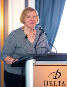 Maureen Douglas Speaking Behind a Podium